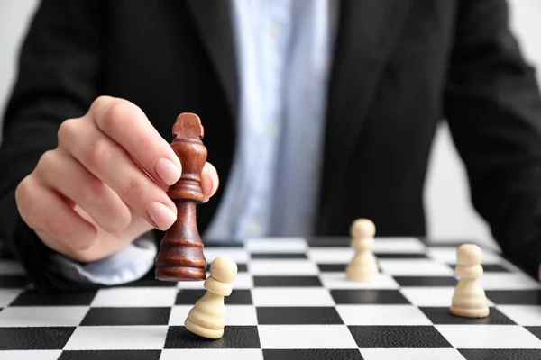 Businesswoman playing chess at table, closeup. Concept of developing strategy for career growth — Stock Photo, Image