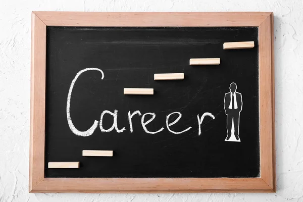 Chalkboard with human figure and word CAREER on table — Stock Photo, Image