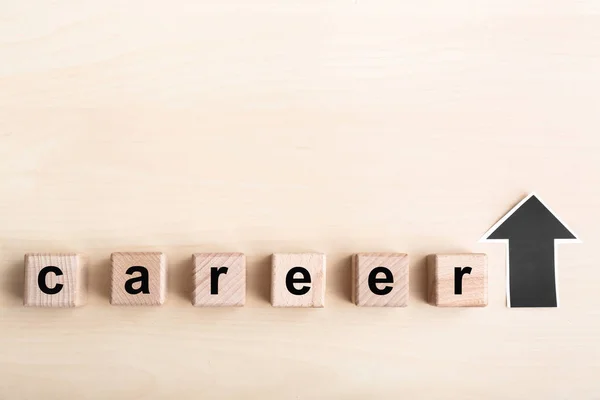 Word career made of cubes and arrow directed upwards on table. Concept of career growth — Stock Photo, Image