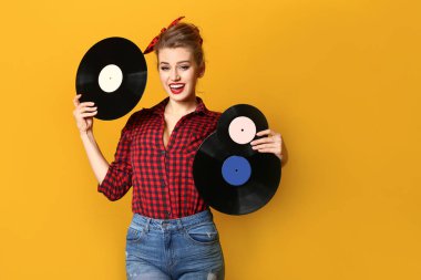 Vinil diskler renk arka plan üzerinde güzel pin-up kadınla