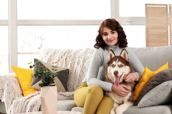 Young woman with her cute dog at home — Stock Photo, Image