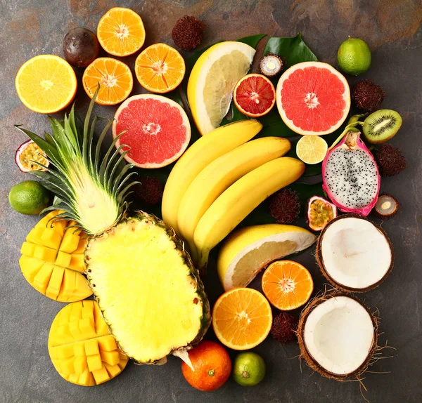 Assortment of exotic fruits on grey table — Stock Photo, Image