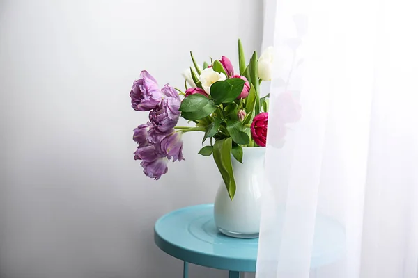 Bouquet of beautiful flowers in vase on table near window — Stock Photo, Image