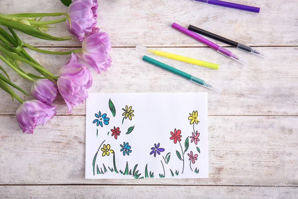 Picture of beautiful flowers with tulips and markers on wooden table — Stock Photo, Image