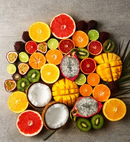 Assortment of exotic fruits on grey background — Stock Photo, Image