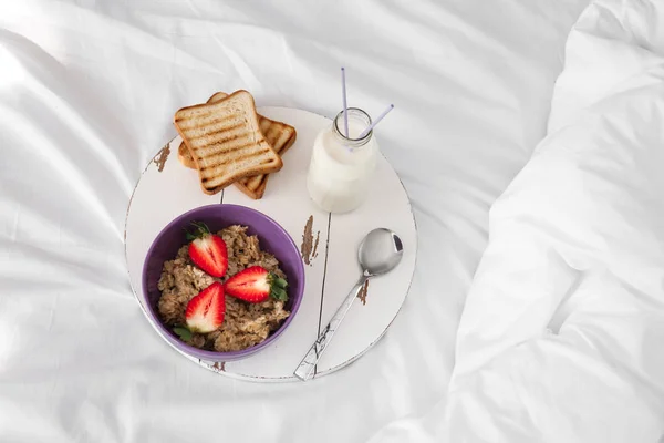 Tasty healthy breakfast on bed — Stock Photo, Image