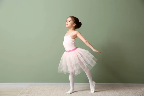Schattige kleine ballerina dansen in de buurt van kleur muur — Stockfoto
