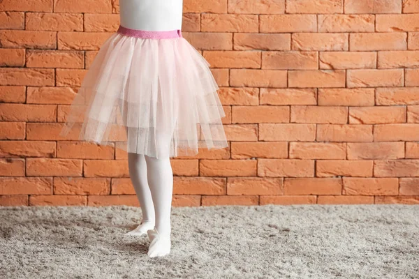 Cute little ballerina against brick wall — Stock Photo, Image