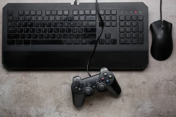 Modern PC keyboard, mouse and game pad on table