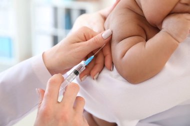 Küçük bebek iğne Kliniği veren çocuk doktoru