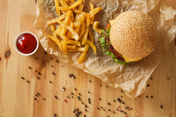 Tasty fresh burger and french fries on table — Stock Photo, Image