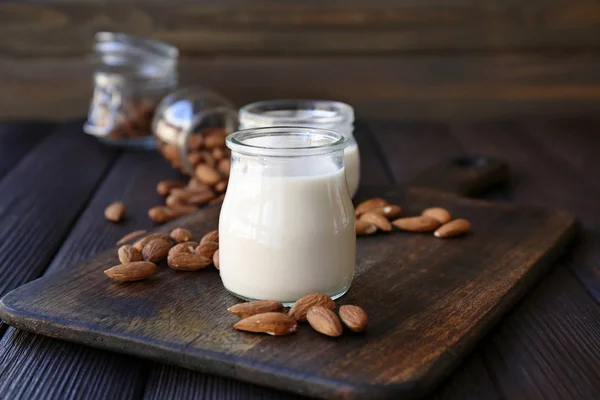 Jars of healthy almond milk on table — Stock Photo, Image