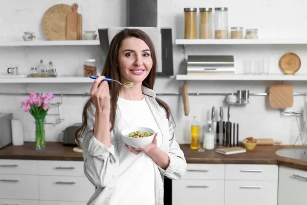 Beautiful woman having breakfast in kitchen at home — Stock Photo, Image