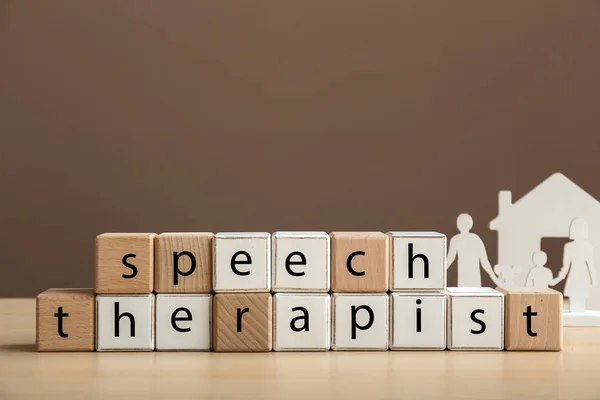 Cubes forming text SPEECH THERAPIST on table