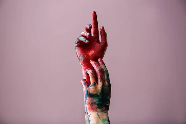 Painted female hands on color background — Stock Photo, Image