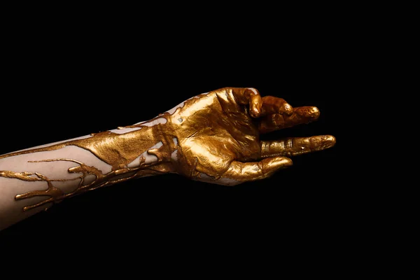 Vrouwelijke hand met gouden verf tegen donkere achtergrond — Stockfoto