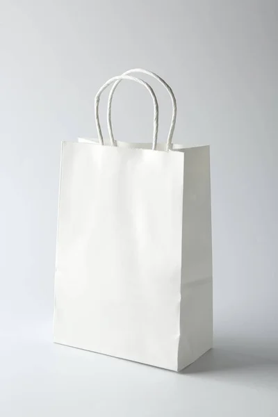 White shopping bag on light background — Stock Photo, Image