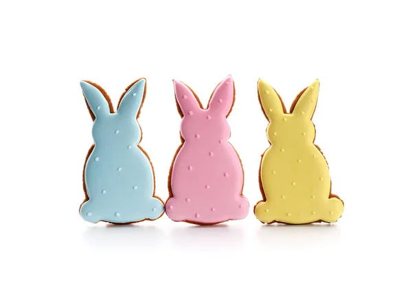 Tasty Easter cookies in shape of bunnies on white background — Stock Photo, Image