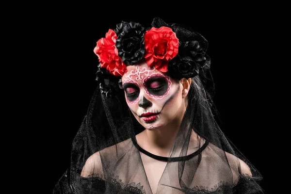 Young woman with painted skull on her face for Mexico's Day of the Dead against dark background — Stock Photo, Image