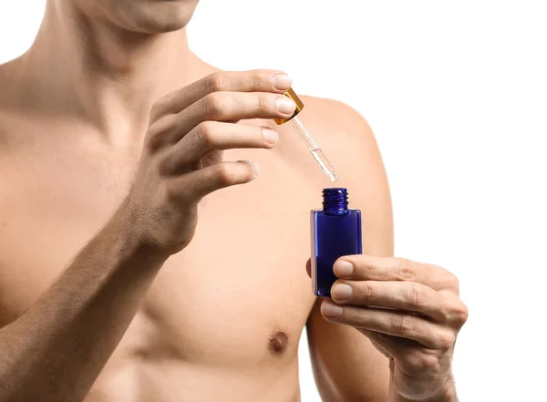 Handsome man with face serum on white background — Stock Photo, Image