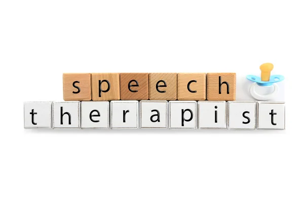 Cubes with text SPEECH THERAPIST and pacifier on white background — Stock Photo, Image
