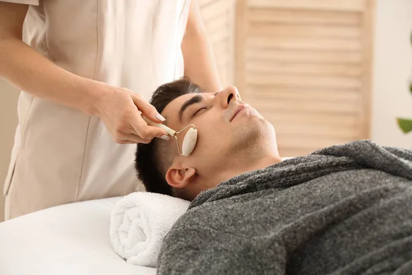 Man receiving face massage in beauty salon — Stock Photo, Image