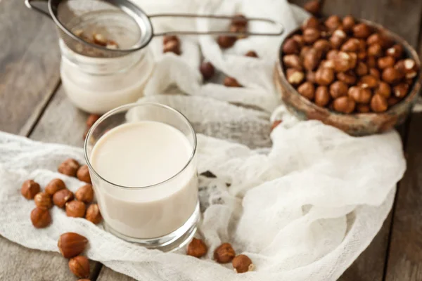 Glass of tasty hazelnut milk on table — Stock Photo, Image