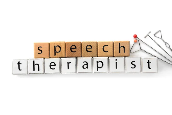 Cubes with text SPEECH THERAPIST and tools on white background — Stock Photo, Image