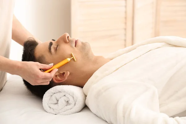 Man receiving face massage in beauty salon — Stock Photo, Image