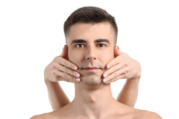 Bonito homem recebendo massagem facial no fundo branco — Fotografia de Stock