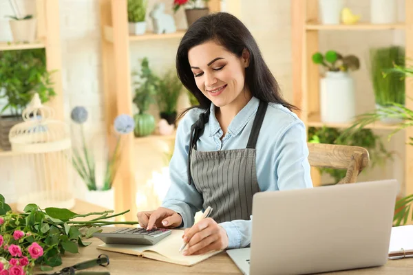 Beautiful female florist working at table — Stock Photo, Image