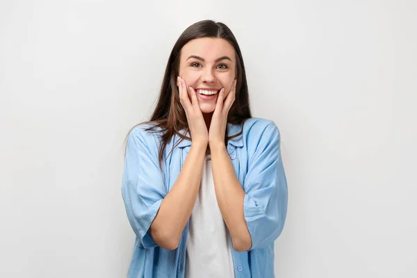 Portrait of beautiful surprised woman in casual clothes on light background — Stock Photo, Image