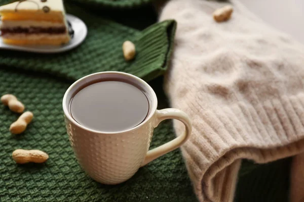 Cup of hot tea on plaid — Stock Photo, Image