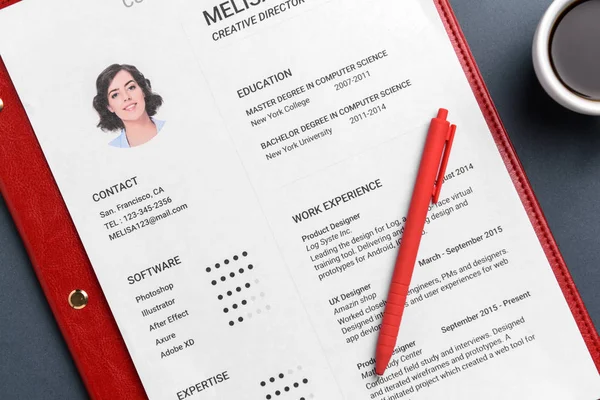 Job resume on grey background, closeup