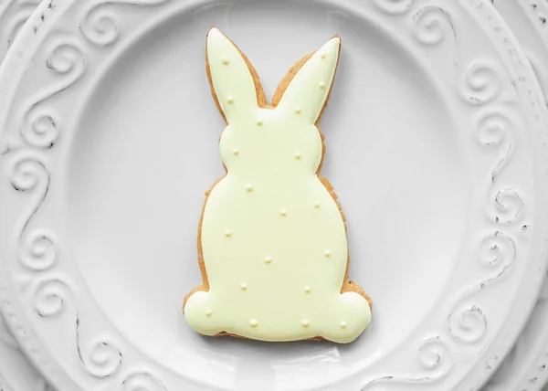 Tasty Easter cookie on plate, closeup