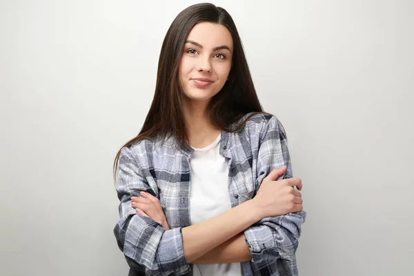 Portrait of beautiful woman in casual clothes on light background — Stock Photo, Image