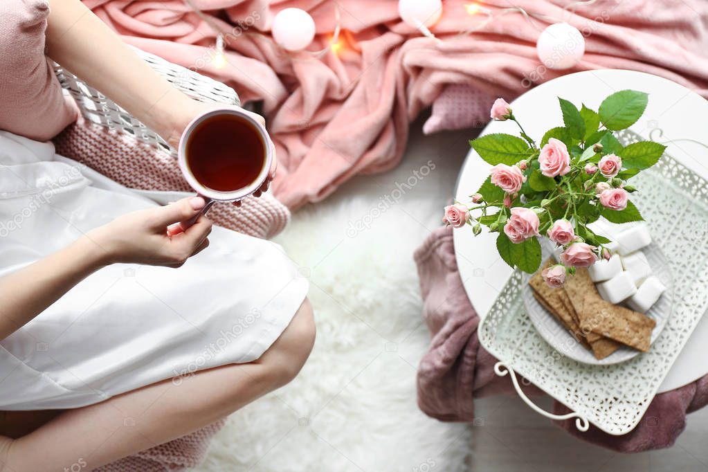 Woman drinking hot tea at home