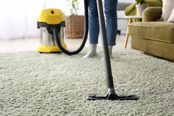 Woman cleaning carpet with hoover at home — Stock Photo, Image