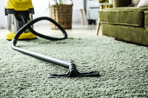 Vacuum cleaner on soft carpet in room — Stock Photo, Image