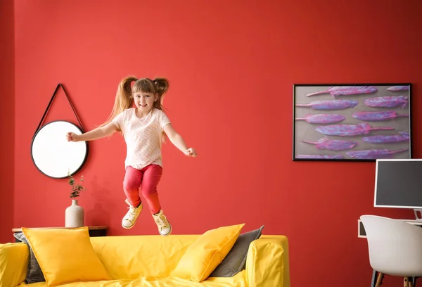 Jumping little girl at home — Stock Photo, Image