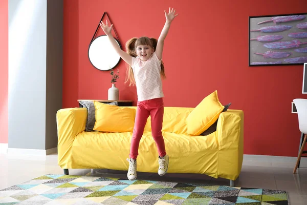 Jumping little girl at home — Stock Photo, Image