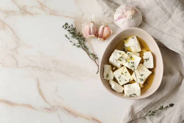 Plate with tasty feta cheese, thyme and olive oil on light background — Stock Photo, Image