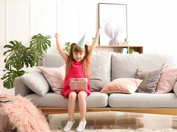 Happy little girl celebrating birthday at home — Stock Photo, Image