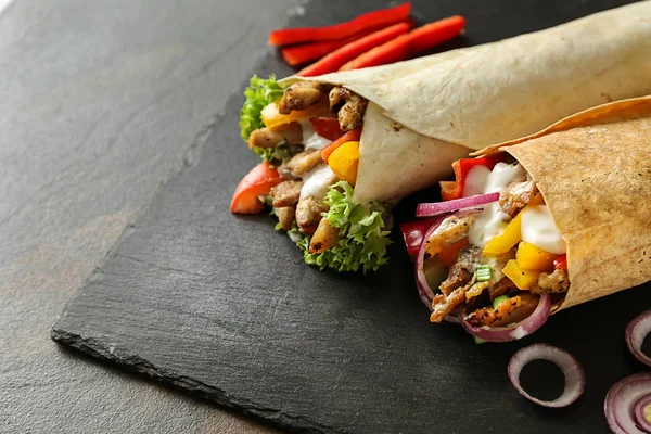 Tasty doner kebabs on slate plate — Stock Photo, Image