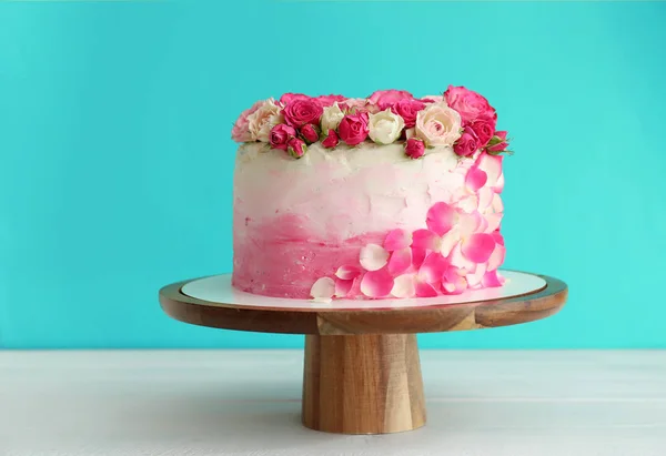 Stand with tasty Birthday cake on white table — Stock Photo, Image