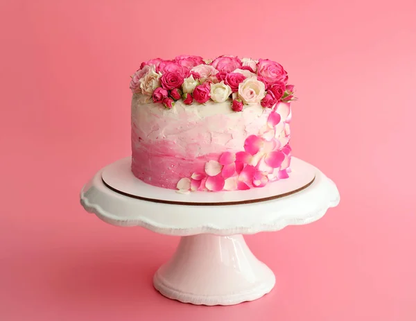 Stand with tasty Birthday cake on color background — Stock Photo, Image