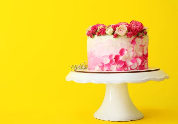 Stand with tasty Birthday cake on color background — Stock Photo, Image