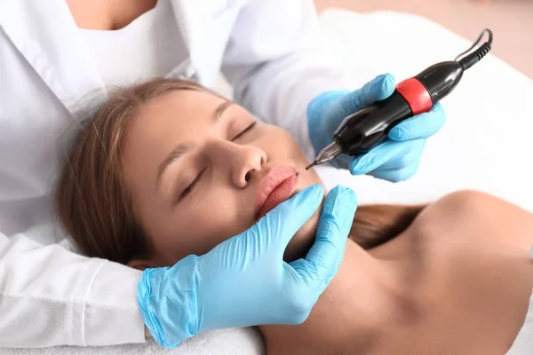 Young woman undergoing procedure of permanent makeup in beauty salon — Stock Photo, Image