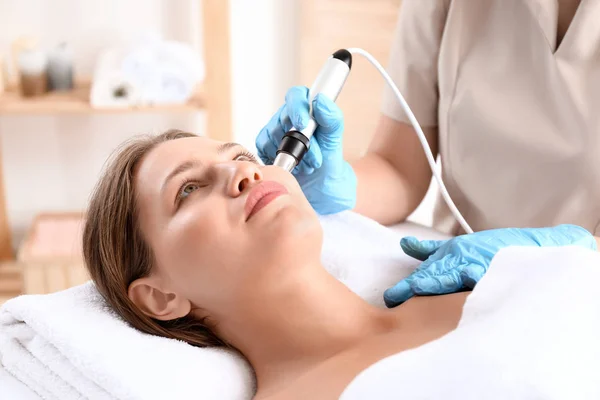 Young woman undergoing procedure of rf lifting in beauty salon — Stock Photo, Image