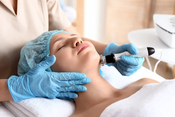 Young woman undergoing procedure of rf lifting in beauty salon — Stock Photo, Image